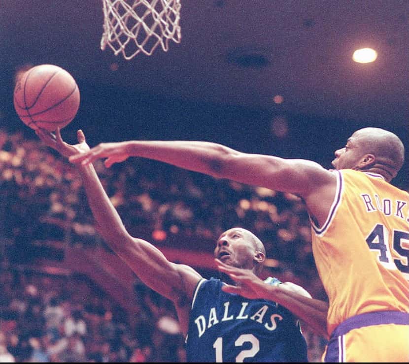 Los Angeles Lakers' Sean Rooks ( right) and Dallas Mavericks' Derek Harper struggle for a...