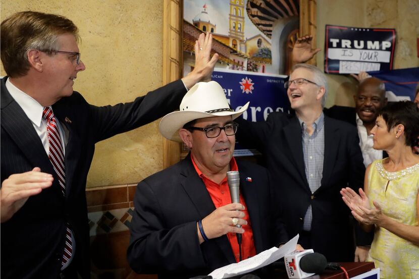 Republican Pete Flores, second from left, talks to supporters as Texas Lt. Gov. Dan Patrick,...