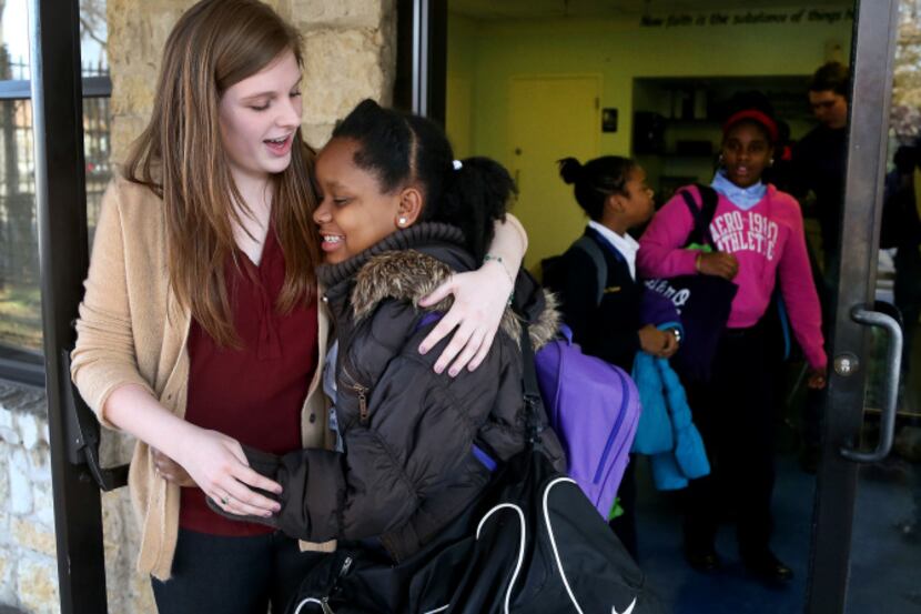 Abilene Christian University student Molly Clemans hugged St. Anthony School student Alana...
