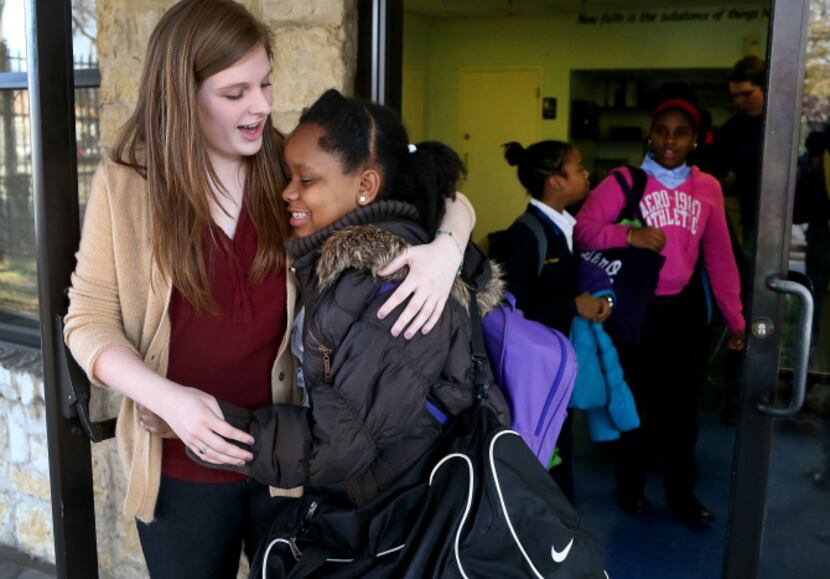 Abilene Christian University student Molly Clemans hugged St. Anthony School student Alana...
