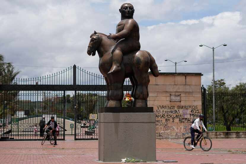 A sculpture by Colombian artist Fernando Botero, titled Man on Horseback, stands outside...