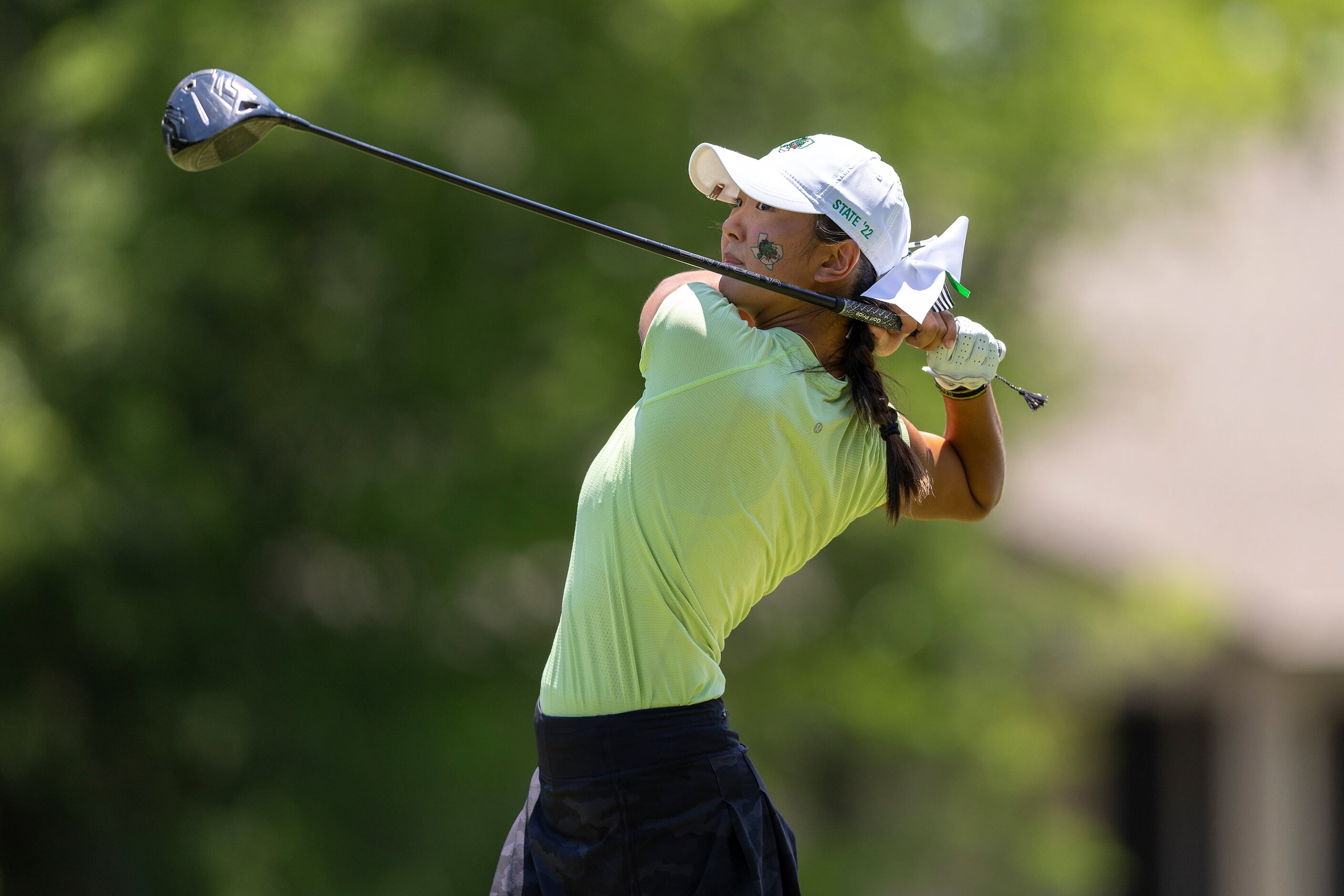 Southlake Carroll’s Ashley Kim hits from the 18th tee box during the 6A girls state golf...