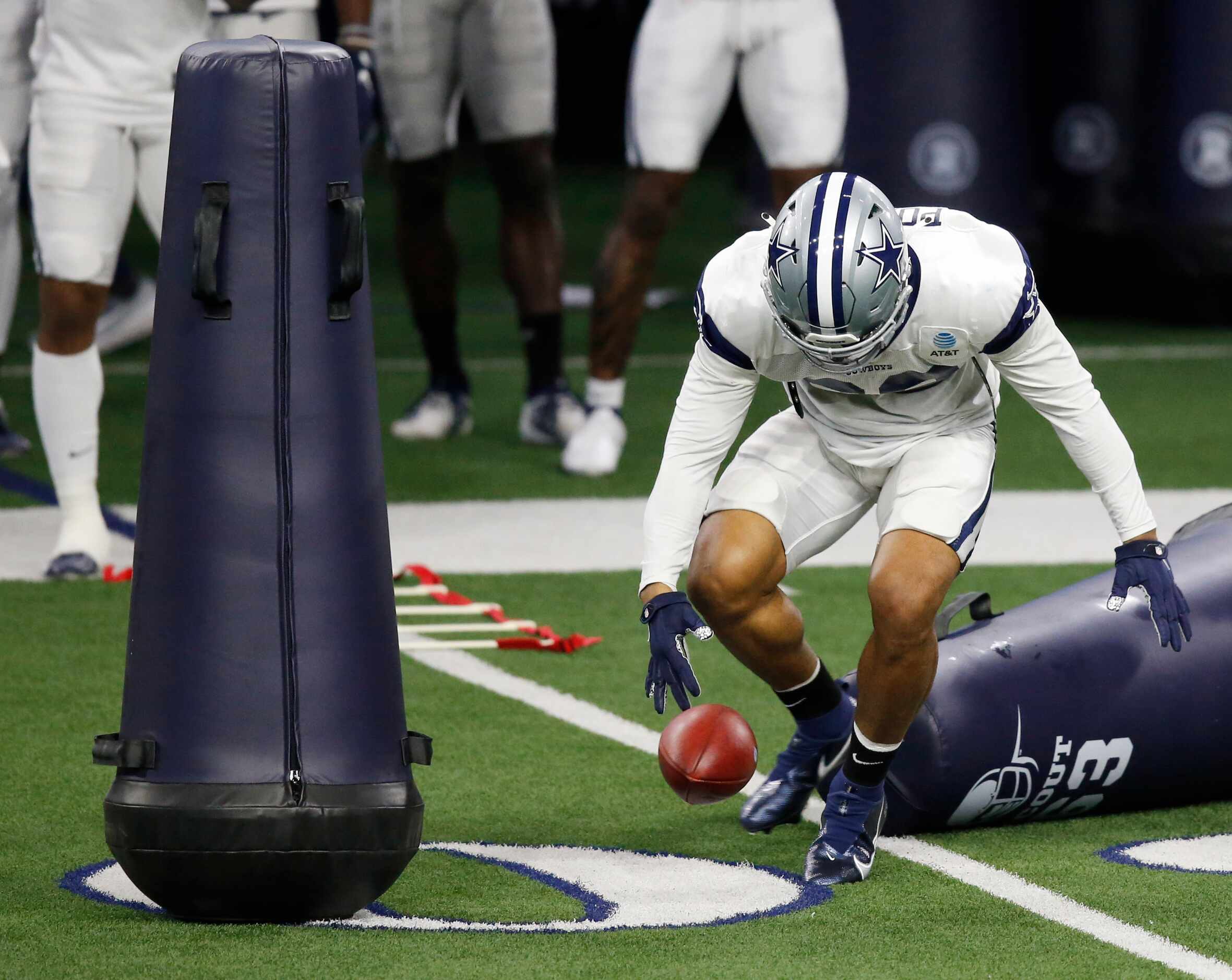 Dallas Cowboys running back Tony Pollard (20) fumbles the ball in a drill in practice during...