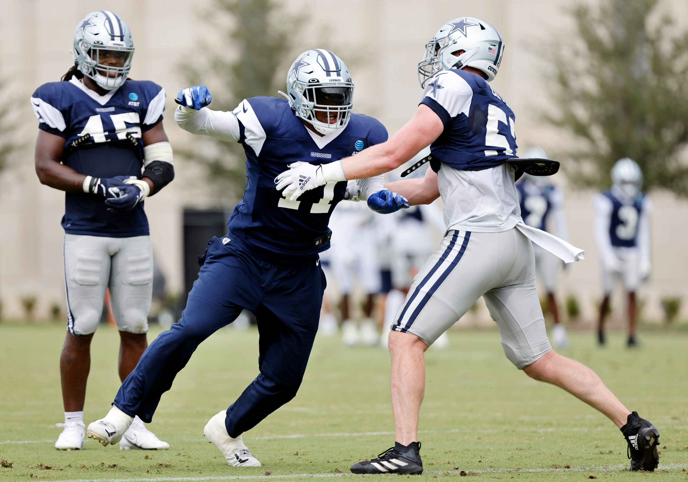 Dallas Cowboys linebacker Micah Parsons (11) pushes off of linebacker Luke Gifford (57) as...