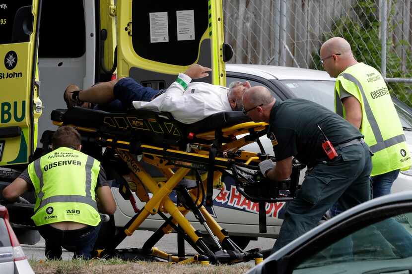 Ambulance staff take a man from outside a mosque in central Christchurch, New Zealand, Friday.