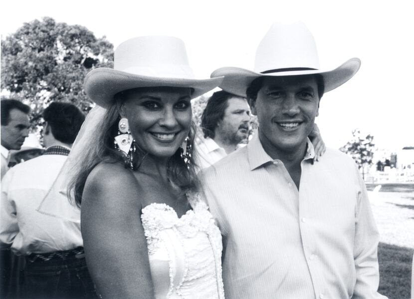 Pamela Graham and George Strait at the 1989 Cattle Baron's Ball where he performed on a dry,...