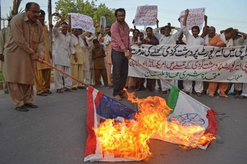 
Pakistani civilians burned Indian and U.S. flags after the airport attack. The Karachi...