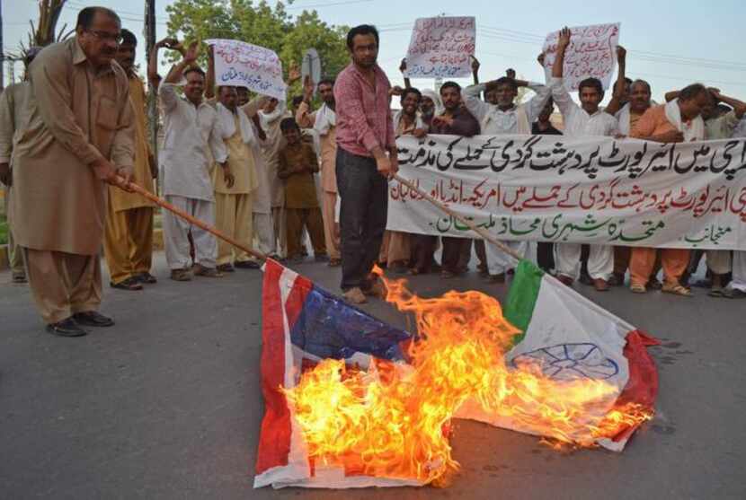 
Pakistani civilians burned Indian and U.S. flags after the airport attack. The Karachi...