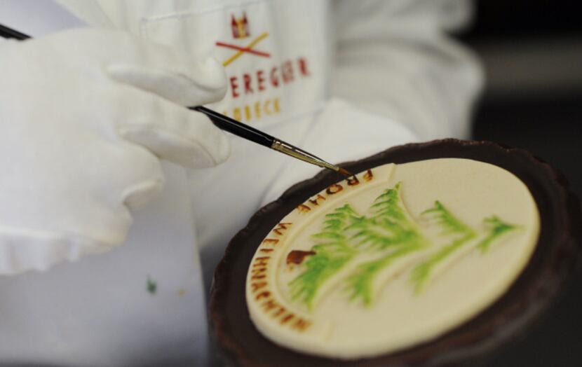 An employee paints marzipan with food color at the traditional company Niederegger in...