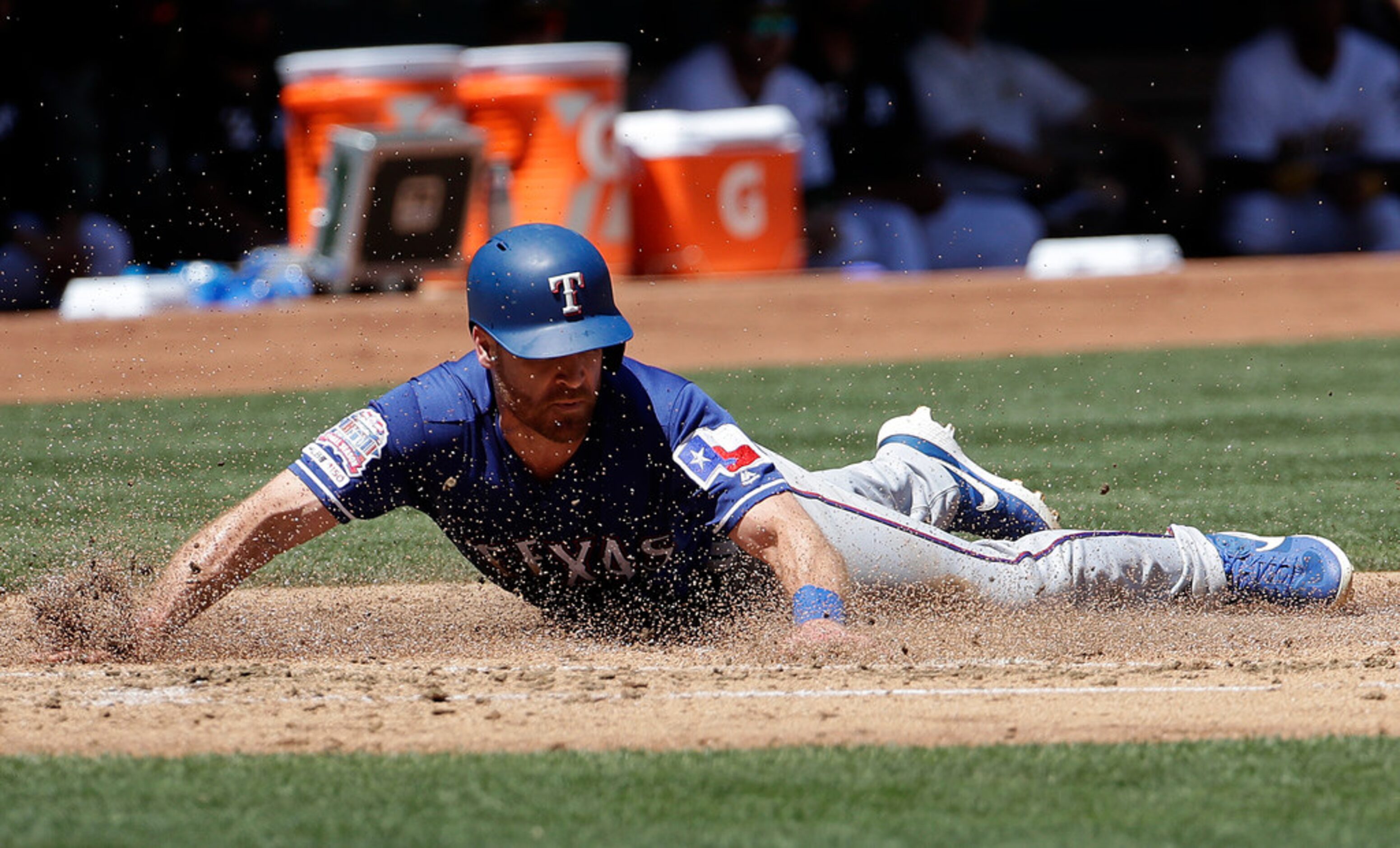 Texas Rangers' Logan Forsythe scores a run against the Oakland Athletics during the second...