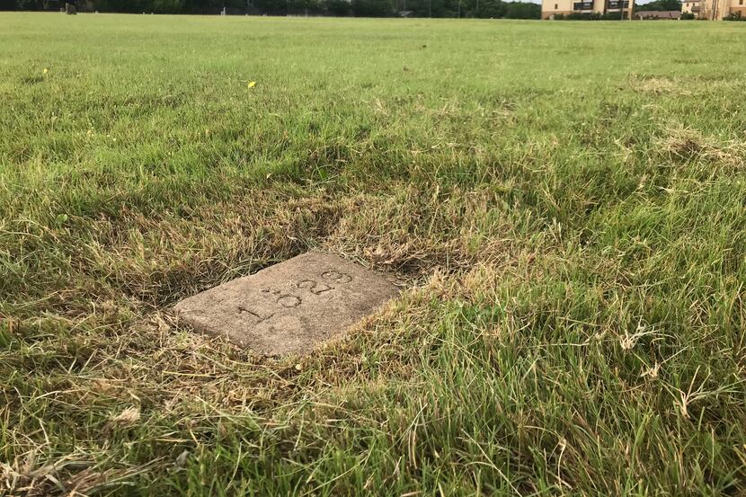 A numbered slab marking the final resting place of a patient who died at the Austin State...