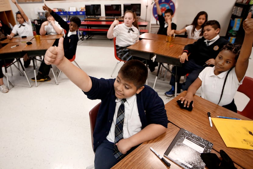 Adrian Torres gives the thumbs up to a correct answer during his fifth grade math class at...
