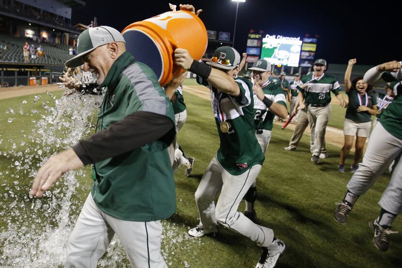 Prosper's head coach Rick Carpenter gets ice dumped on him by Cam Wood (12) and Kylor Morris...