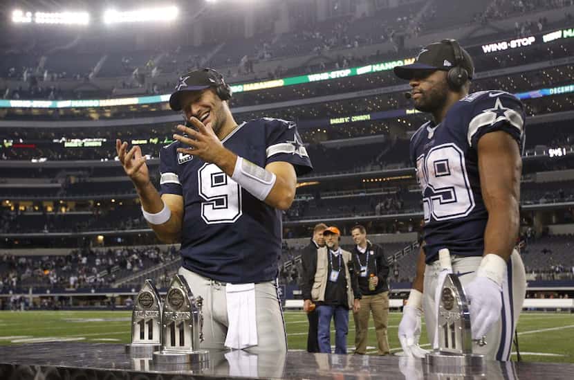 Dallas Cowboys quarterback Tony Romo (9) and running back DeMarco Murray (29) received the...