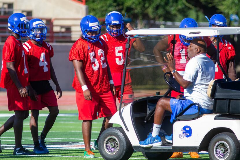 Duncanville coach Reginald Samples (right) coaches his players at Panther Stadium on the...