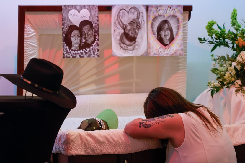 Tona Southards, mother of Jon Anthony Southards, leans over her son’s casket ahead of his...