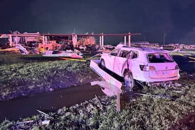 Tornado damage at a Shell gasoline station near Interstate 35 and Lone Oak Road on Sunday,...