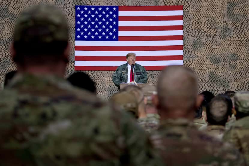 President Donald Trump speaks to members of the military at a hangar rally at Al Asad Air...