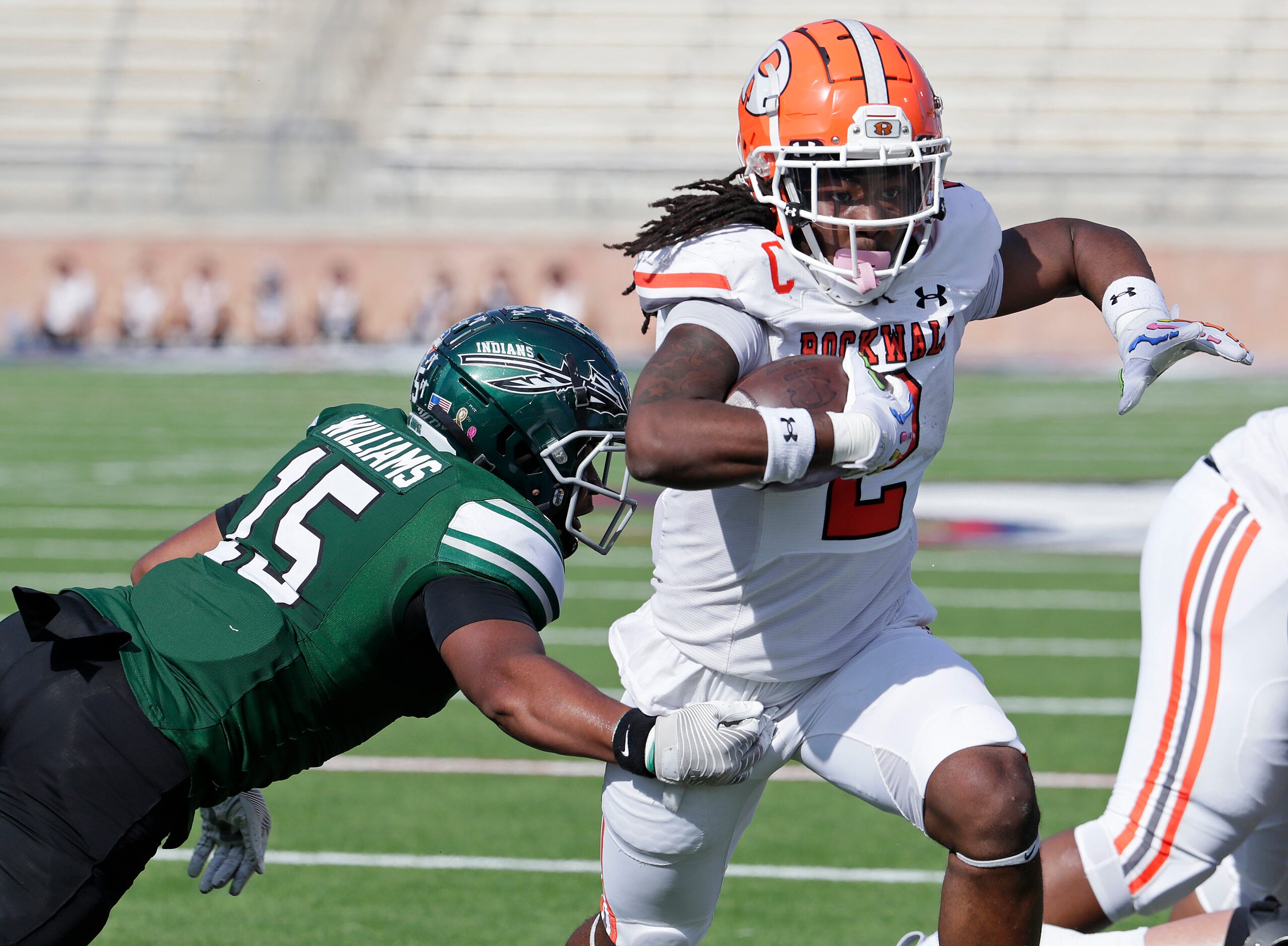 Rockwall High School running back Ashten Emory (2) runs past Waxahachie High School...