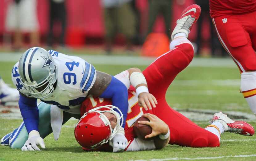 Dallas Cowboys defensive end DeMarcus Ware (94) sacks Kansas City Chiefs quarterback Alex...