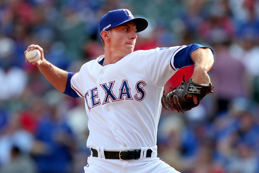 ARLINGTON, TEXAS - MARCH 28: Kyle Dowdy #43 of the Texas Rangers pitches against the Chicago...