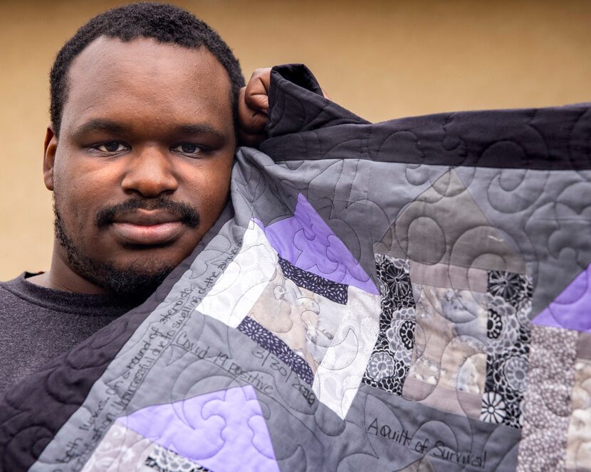 Kerry Parks poses with the survivor's quilt that his mother-in-law, Marva Stephens, began...