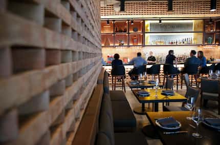 A floor-to-ceiling wall of clay bricks from Mexico bisects the dining room at Don Artemio in...