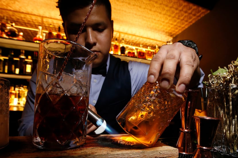 Cliff Felipe Flores makes a house smoked old fashion at ABV Establishment in Dallas on May...