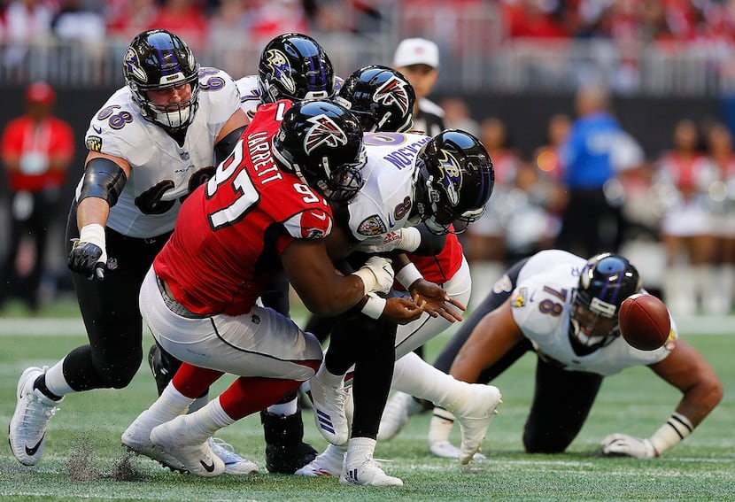 ATLANTA, GA - DECEMBER 02:  Lamar Jackson #8 of the Baltimore Ravens fumbles the ball as he...