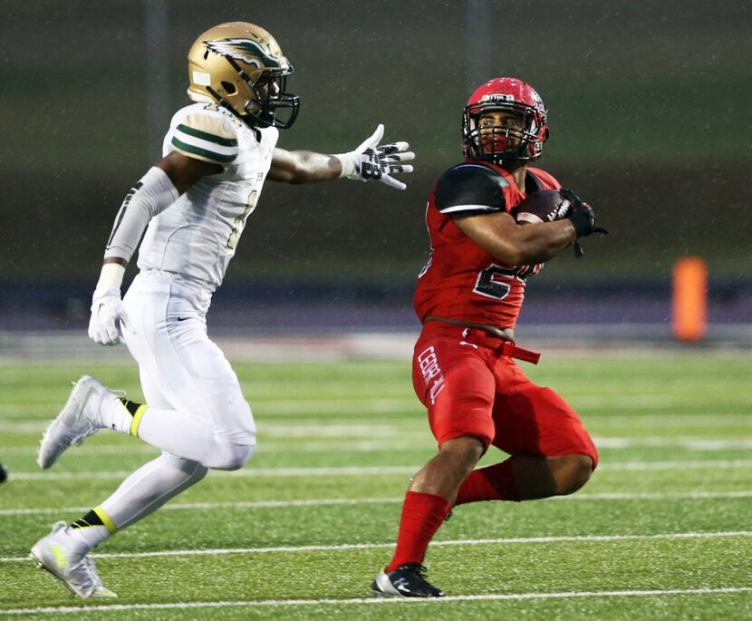 Cedar Hill's Kaegun Williams (24) attempts to break away from DeSoto's Isaiah Stewart (13)...