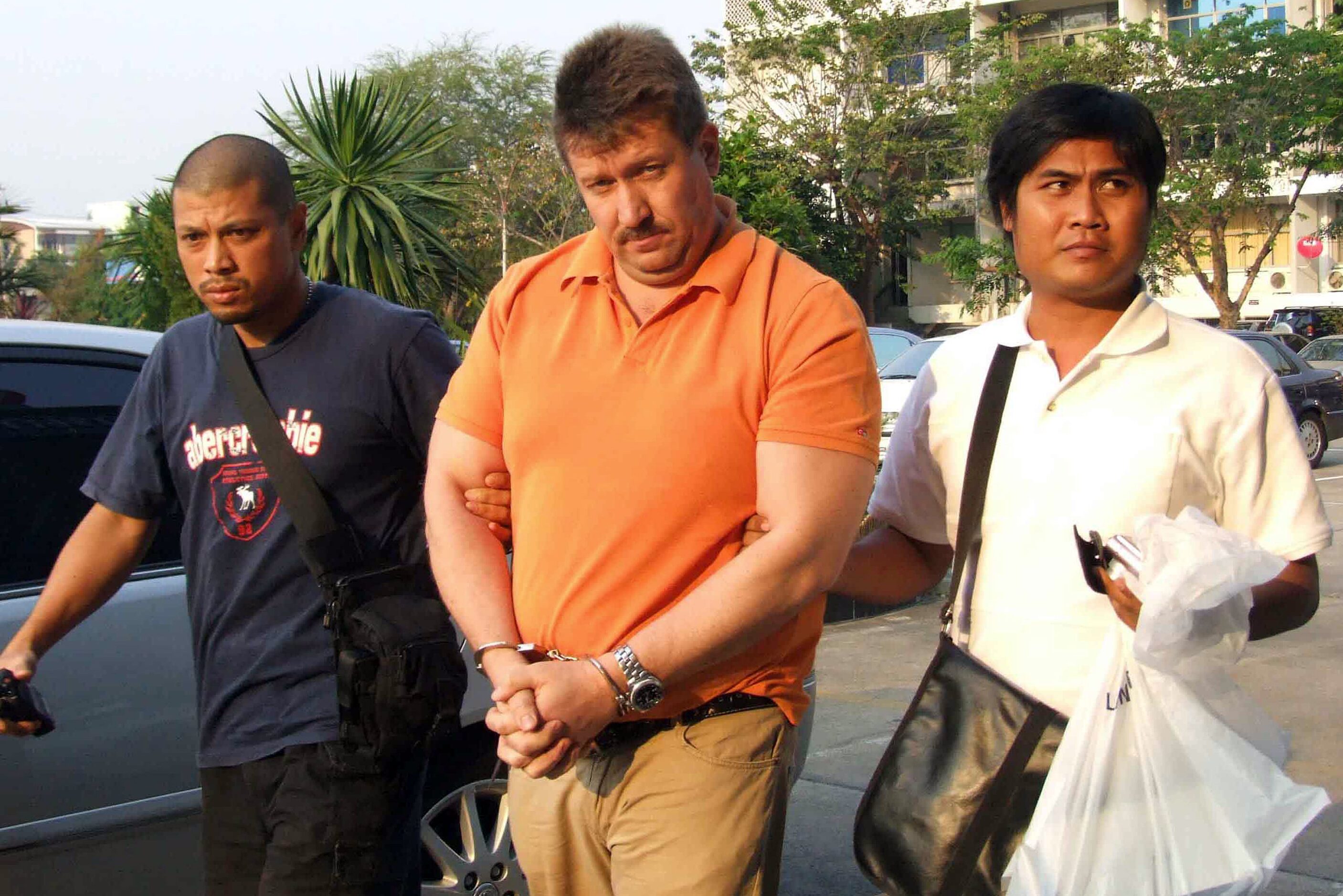 Thai security officers escort suspected Russian arms dealer Viktor Bout at the head of the...