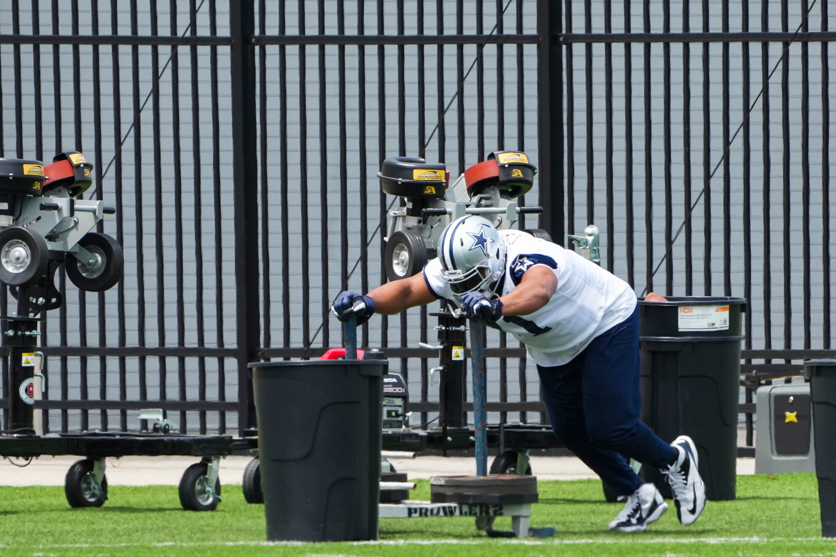 Dallas Cowboys tackle La'el Collins pushes a weighted sled during a minicamp practice at The...
