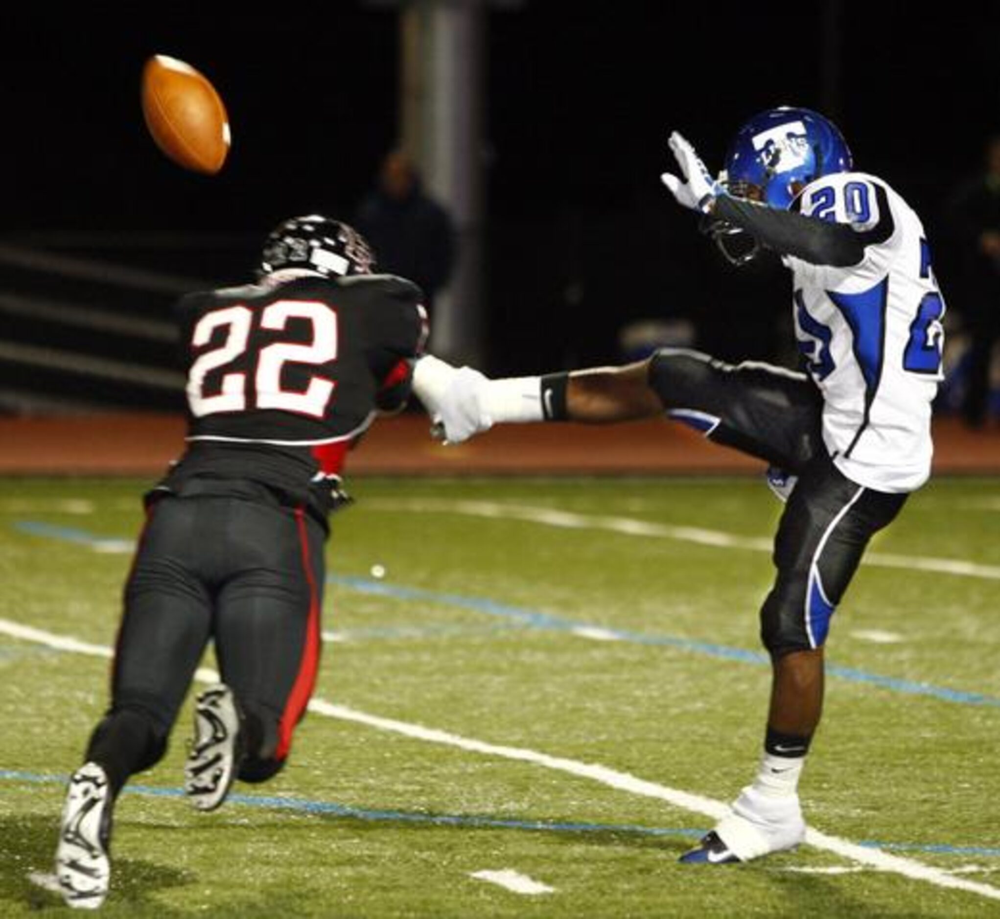 Rockwall-Heath's JEB Smartt (22) blocks a punt by Carrollton R.L. Turner's John Umana (20)...