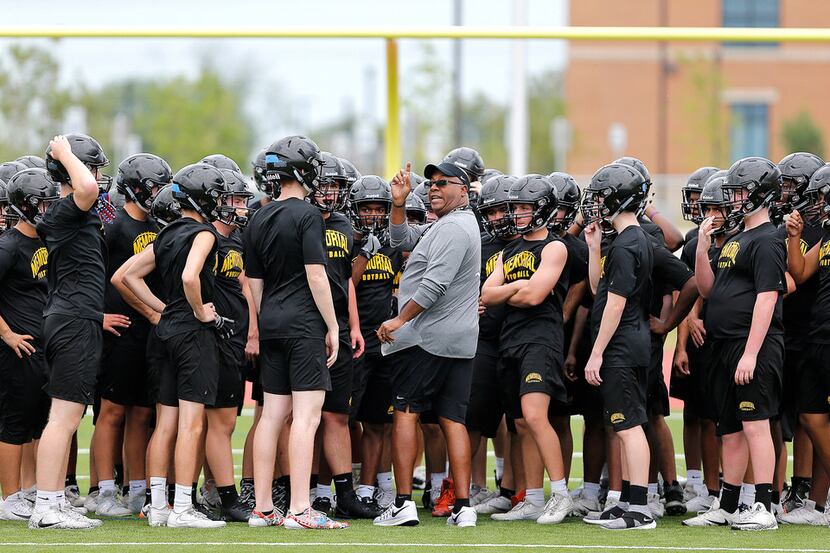 Head Coach Derick Roberson gives instruction to his team during the first spring football...