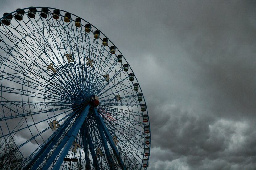 Storm clouds pass over the Texas Star ferris wheel at Fair Park in Dallas, Monday, March 21,...