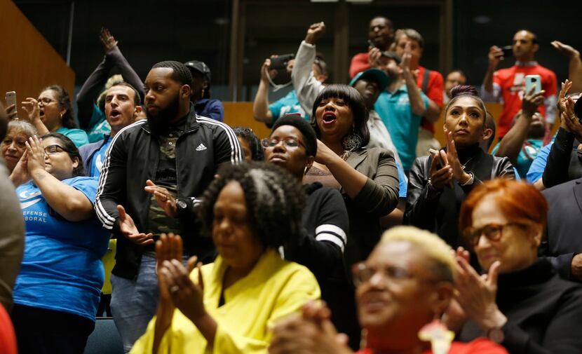 People celebrated after Wednesday's Dallas City Council vote to require employers to offer...