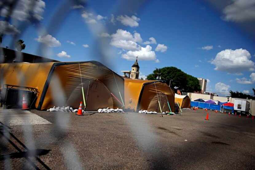 
Temporary tents sit in the parking lot at Sacred Heart Catholic Church Wednesday, July 2,...