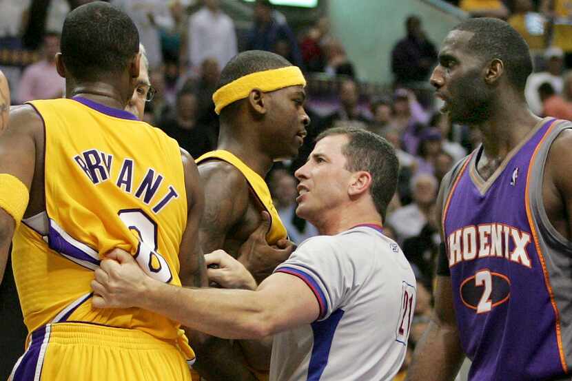 FILE - NBA official Tim Donaghy separates Phoenix Suns and Los Angeles Lakers players during...