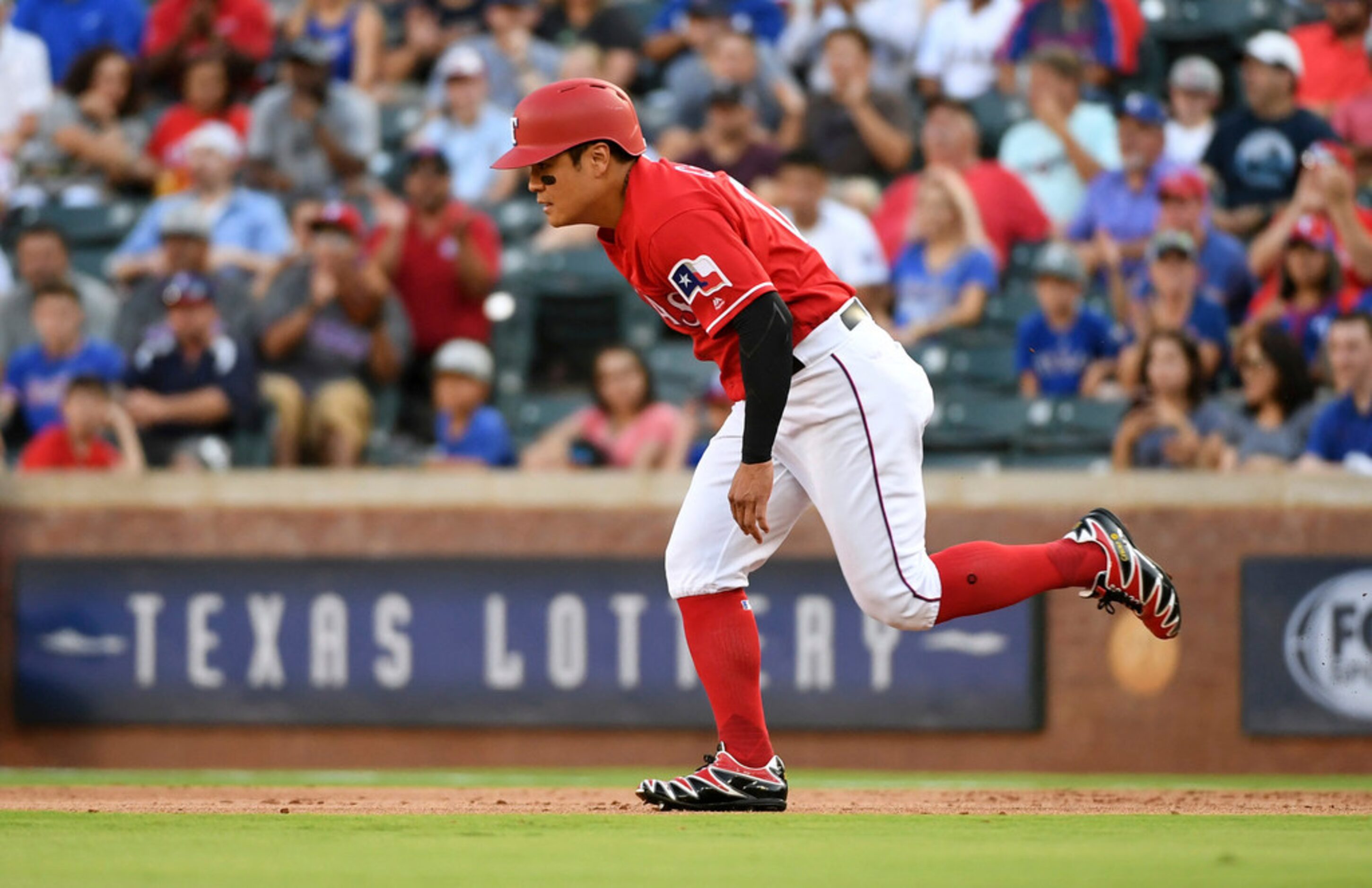 Texas Rangers' Shin-Soo Choo runs toward second base on a single by Elvis Andrus during the...