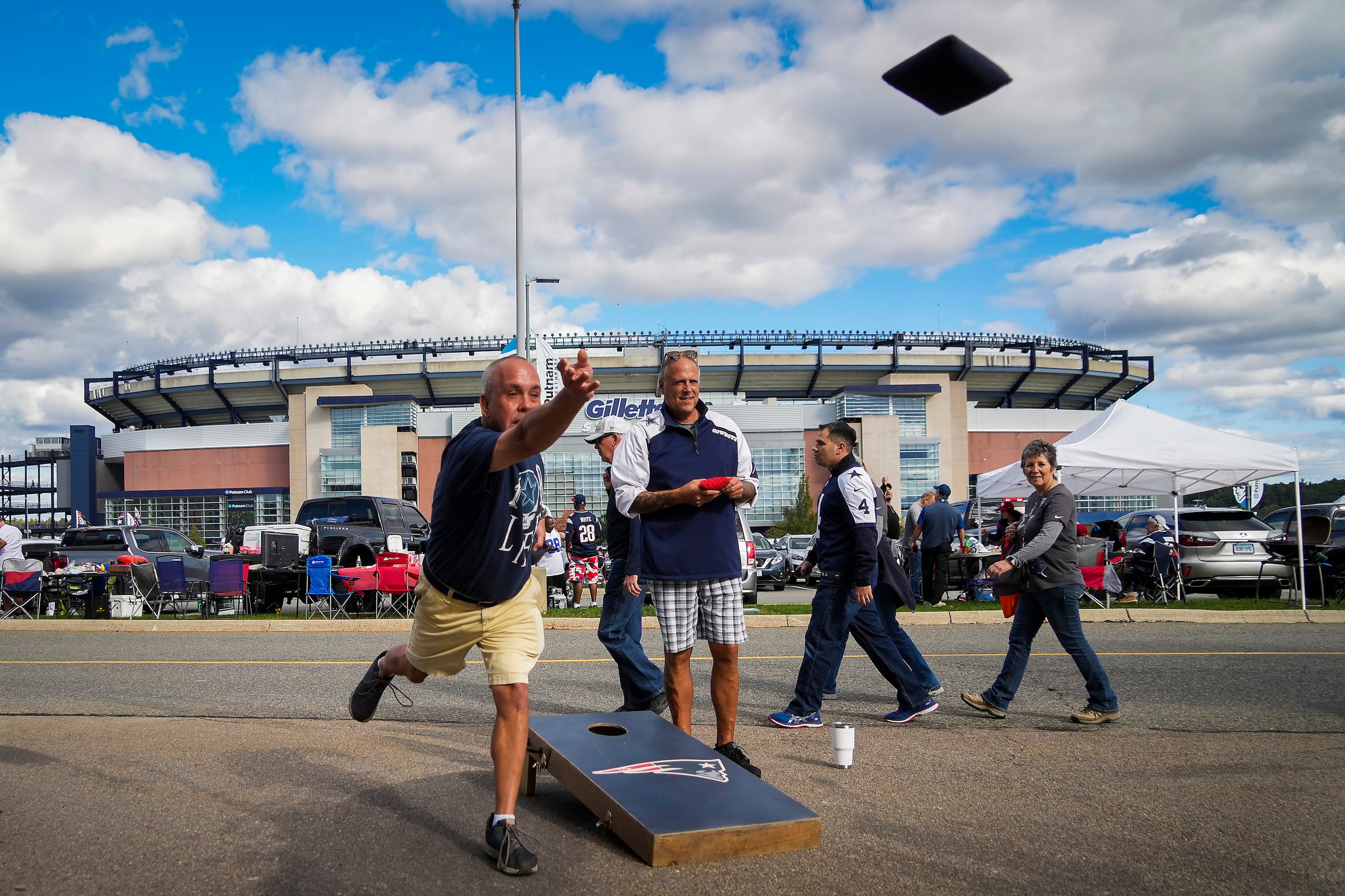Dallas Cowboys fan Tim Ryan plays cornhole in while tailgating before an NFL football game...