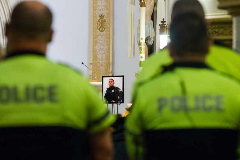 A photo of Dallas Officer Rogelio Santander was displayed on the altar during a Mass in...