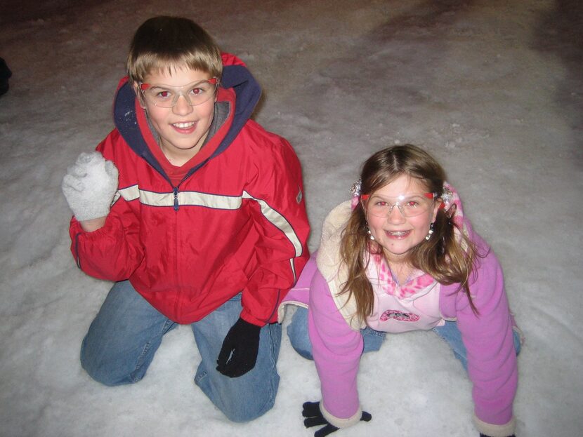 Matt and Katie Domagala play in “snow” brought in by town staff for Flower Mound’s Christmas...