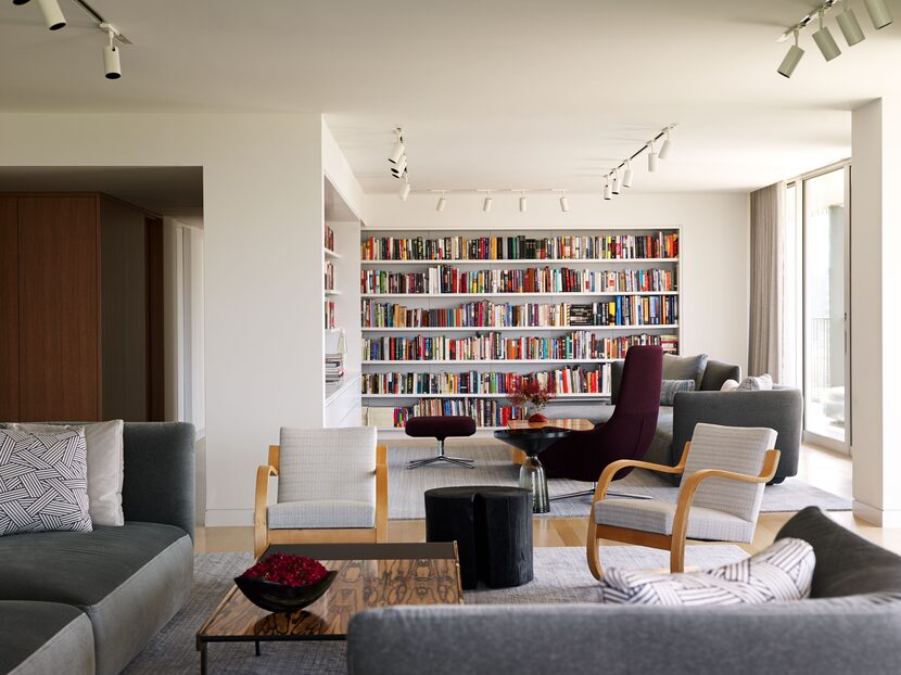 The library and living rooms are continuous, but have visual hints—like the bookshelves and...