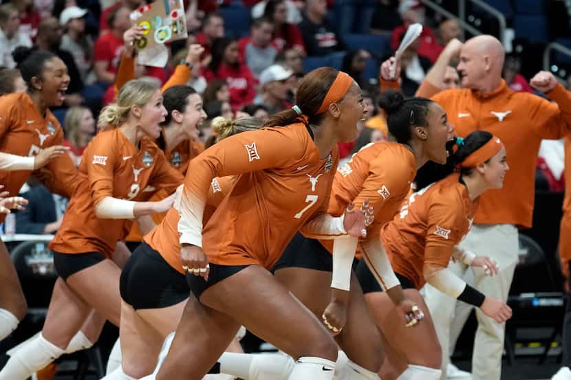 Texas players react after the team defeated Wisconsin during a semifinal match in the NCAA...