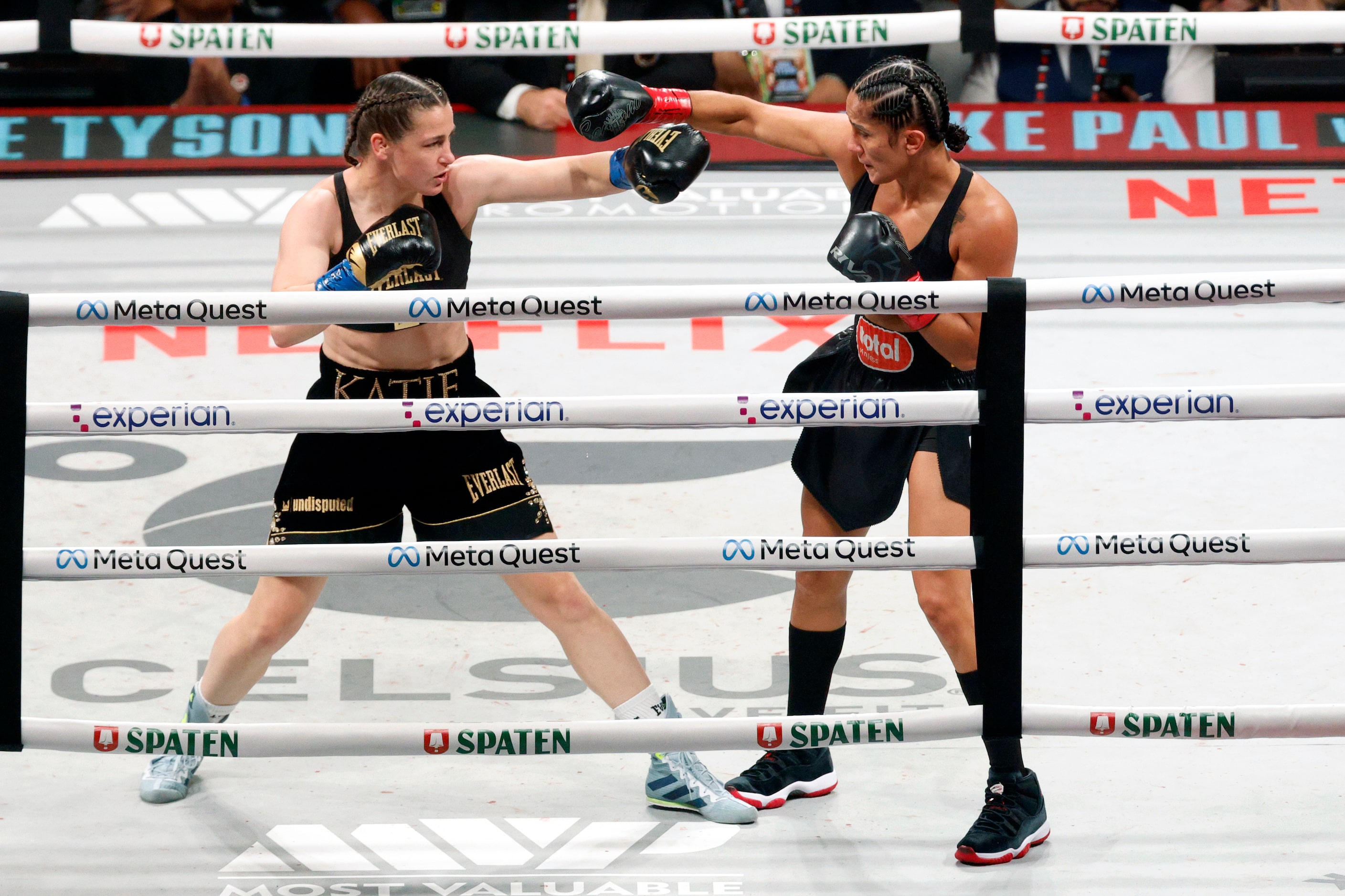 Katie Taylor (left) and Amanda Serrano trade punches during round one of the undisputed...