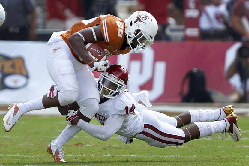 Oklahoma Sooners defensive back Aaron Colvin makes a sdivng tackle of Texas Longhorns safety...