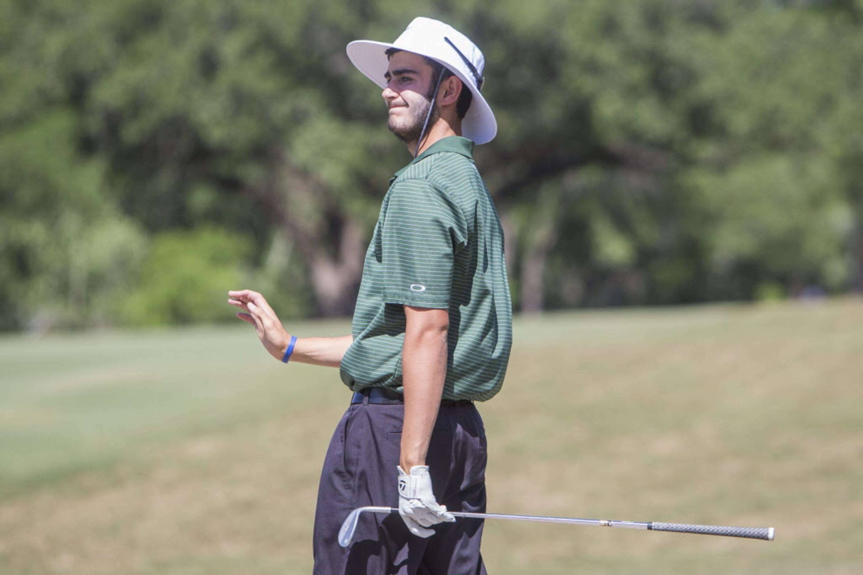 Southlake Carroll junior Trent Hill smiles after a shot to the fifth green during the UIL 5A...
