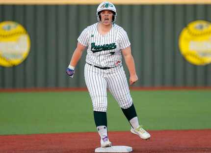 Prosper High School’s Sydney Lewis (7) shouts to her dug out after hitting a double in the...