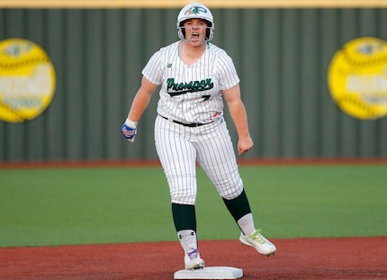 Prosper High School’s Sydney Lewis (7) shouts to her dug out after hitting a double in the...