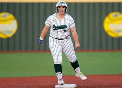 Prosper High School’s Sydney Lewis (7) shouts to her dug out after hitting a double in the...